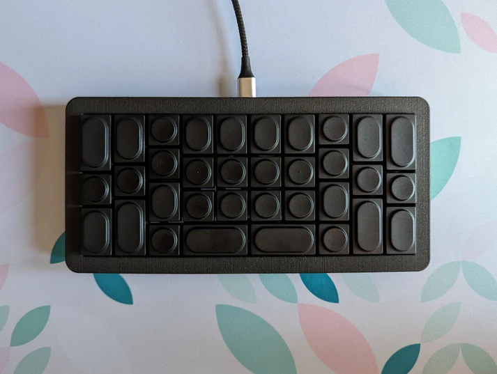 A built Bruce in the Not a Human case with Black Doys keycaps